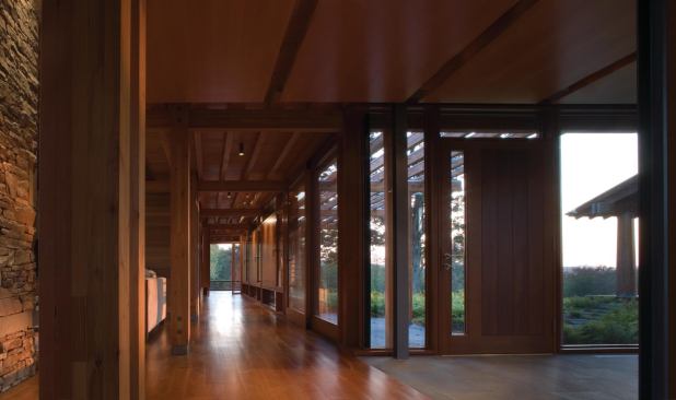 The interior corridor intersects with the glass passageway to the cottage.

