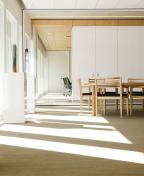 The project features glass screen walls and conveys the client's appreciation for design.