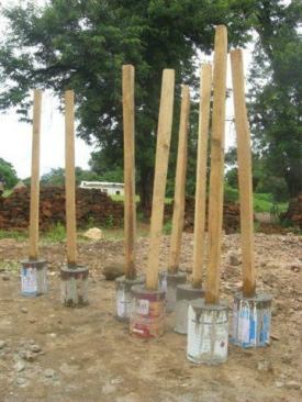 The soil under the slab was compacted by hand by pouring concrete into a paint bucket and stamping the entire footprint until level and compacted.