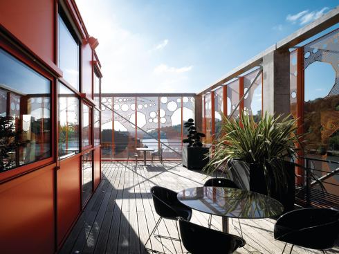 The buildings perforated aluminum skin forms the enclosure for the sixth-floor terrace.