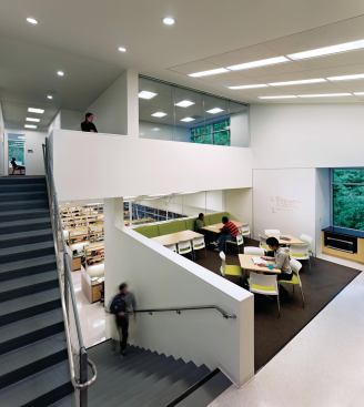 Informal gathering spaces perch on half-floors between the lab levels to encourage interaction between researchers on different teams.