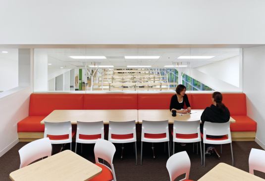 Where the floor plates split, meeting and dining rooms overlook labs on the level below.