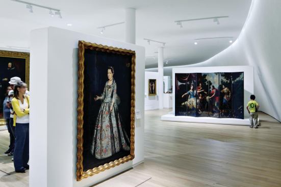 Since art cannot be hung off of the curving, elastomeric-coated interior walls, paintings are hung on freestanding partitions.