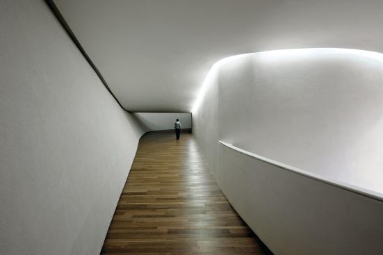 Sinuous circulation ramps lead from floor to floor and gallery to gallery.