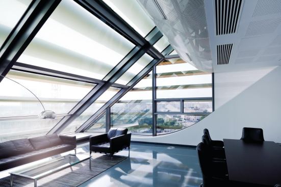 On the western edge of the building, an office’s slanted glass wall offers views out over Montpellier.