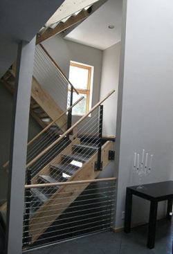 Though the original stairs had a contemporary look, the homeowners wanted a more elegant design than one made with standard cable rail and wood.