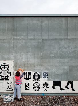 Students designed icons for the Lego walls and helped with construction. The original plan was for the icons to be multicolored, but the number of available hues proved overwhelming, so a decision was made to go with black. (The red bricks throughout the façade delineate the layout grid.) As What_architecture director Anthony Hoete notes, "The school was very keen that this populist façade attempt be a little timeless ... and so it borrows the black and white from modern architecture's palette."