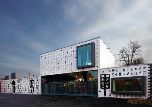 The Lego façade of What_architecture's addition faces the courtyard of the Cowley St. Laurence Church of England Primary School and Children's Centre, where it is visible to students, teachers, and visiting parents. The structure to the right is for administrators, while the one to the left is part of the children's center. In between them, above the entrance gate, is a room for school staff.