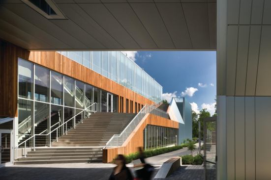 Sustainably harvested ipe is used as part of the LEED Gold strategy. It will weather to gray, relating in tone to the metal panels. The building's top floor is a fully glazed box that floats over Kohl plaza on the buildings west face. A custom frit pattern helps increase the glazings shading coefficent to 0.28 while adding another shade of gray to the palette. Over time, The building will become a series of gray tones as a backdrop for a vibrant art, Kurtz says.