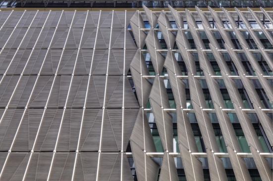 The motorized system is mounted vertically, allowing entire columns of fins to move in tandem.