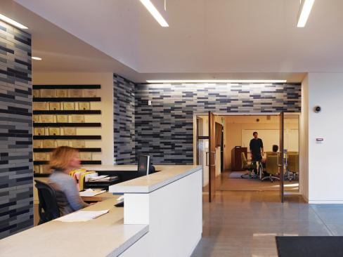 The reception area serves as the main point of entry, not only to the operations and laboratory area, but also to the education area, which is the part of the program most accessible to the public. Visitors enter into a space lined with Heath Ceramics tile, another local resource, and can proceed to conference rooms and other areas beyond.