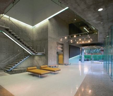 Using the idea of a camera obscura—an optics tool used to study light—as the project's design inspiration for the volumetric play of space within the building, the architects create a dialogue between “light” and “dark” relying on a combination of daylight and readily available sources. In the lobby linear fluorescent T8 fixtures define the underside of the stair and perimeter edges of the light shaft—one of three in the project.