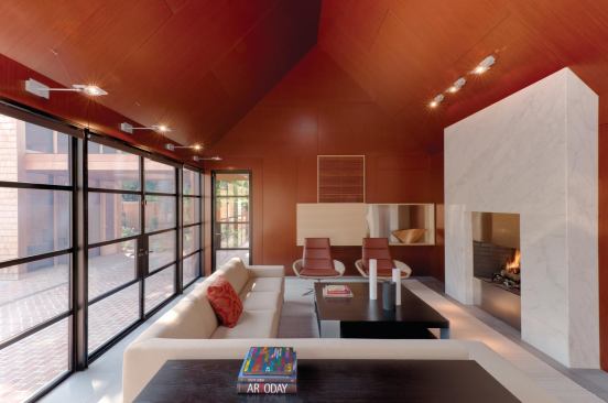 2012 CHDA  Renovation 308 Mulberry, Lewes, Del.  Entrant/Architect: Robert M. Gurney, FAIA, Architect, Washington, D.C.; Project architect: Brian Tuskey, Robert M. Gurney, FAIA, Architect; Builder: Ilex Construction, Easton, Md.; Photographer: Maxwell MacKenzie    The kitchen/living pavilion has mahogany walls and ceilings, basalt flooring, white marble counters and fireplace, and stainless steel cabinetry.