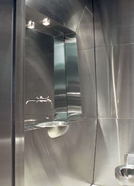 Contrasting the master bath’s rhapsody in blue, the powder room is a symphony in stainless steel.