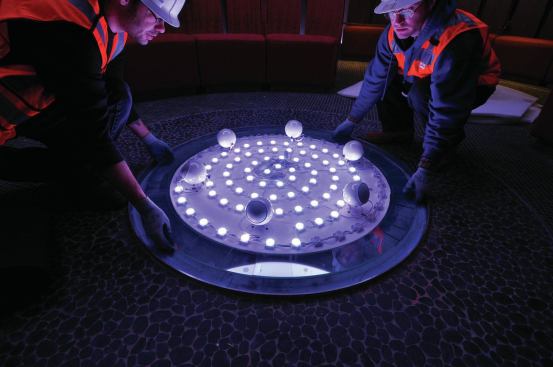 Two strings of color-changing, linear LED fixtures, programmed with individual nodes, simulate the rippling of water on the surface of the glass, which is textured to add to the overall effect.