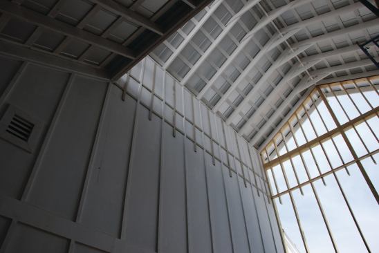 An interior image of St. Patrick's, which features a tall wall of windows behind the altar that gives parishioners a connection to the outdoors.
