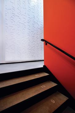 Brightly colored paint and numbers on the stair treads are among the inexpensive measures used to make the space child-friendly.