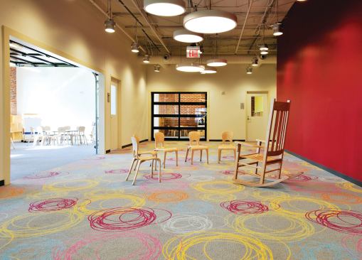 Rolling garage doors separate the classrooms from the main play area (pictured). With all the doors opened, the combined space can be used to host events.