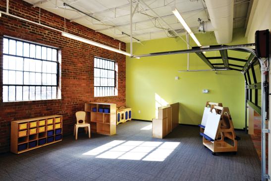 Rolling garage doors separate the center’s preschool classrooms (pictured) from the main play area. With all the doors opened, the combined space can be used to host events.