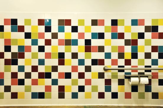 The tropical color scheme extends to the center’s six restrooms, all of which have multicolored tiles.