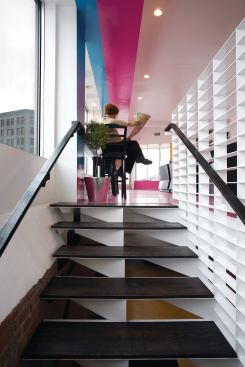 The staircase leading down to the basement level is also made from laser-cut steel, this time coated white. The angular construction of the risers mimics the geometry of the counters and the color fields in the ground floor space--which were achieved using an epoxy coating from Kwasny Flooring and Lining Systems--while the more sedate palette of black and white transitions into the less visually energetic brick space below.