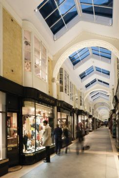 Downlights provide a brighter zone of illumination around the shop entrances.