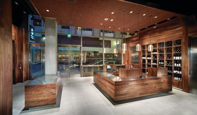 The cash wrap in the main reception space is a microcosm of the overall materials palette--which includes American black walnut, stainless steel, cork fabric, and concrete. EGRESS SIGNAGE - Sure-Lites - ELX Series recessed exit sign - sureliteslighting.com - RECESSED DOWNLIGHTS - LiteFrame - 4" recessed low-voltage downlights - prescolite.com/brands/liteframe.php