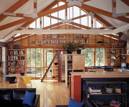 The architects designed an alternating-tread staircase of oak and maple that lets them reach the upper shelves.