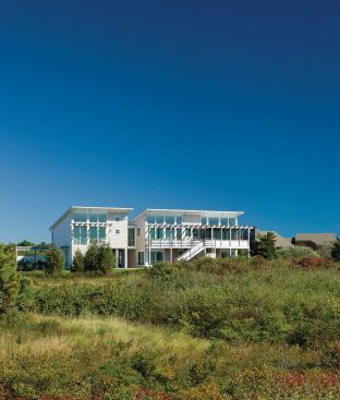 Custom, stainless steel railings grace both the exterior and the interior of the Cooperstein House in Truro, Mass.
