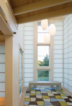 A double-height entry hall provides a sunny introduction to the house.