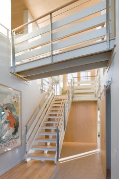 The two-story stairwell funnels light into the home's center.