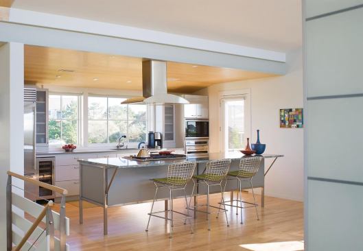 Plywood panels add a touch of warmth to the kitchen ceiling.
