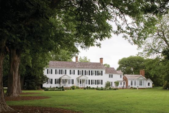 The rear, creekside elevation after being renovated and restored by Muse Architects. Two newly added porches replicate those on the front facade.
