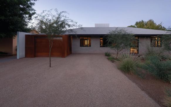 The street elevation of the 1950s ranch retains much of its original character.


