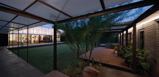 This addition/renovation uses a detached live/work pavilion and garden walls to enclose a multipurpose outdoor living space.

