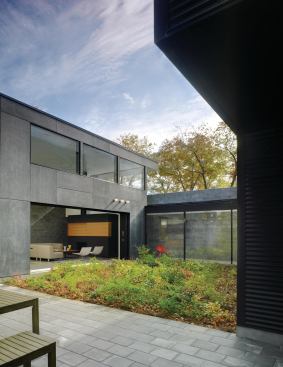  A glass entry corridor links the two courtyard-enclosing volumes.