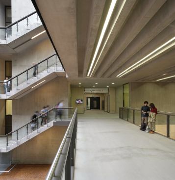Concrete and steel walkways are lit with 4000K neutral white light, which differentiates them from the other circulation and gathering spaces on campus that are lit with 3000K.