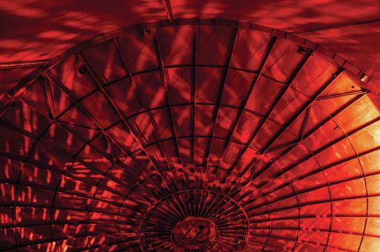 When natural light is seasonally available, the red-painted interior is infused with dappled sunlight. 