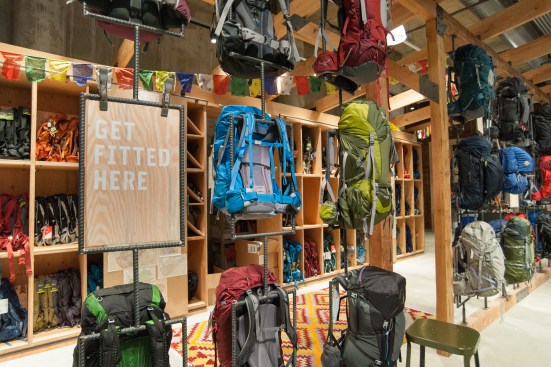 Custom rotatable display racks made of rebar allow visitors to see all sides of backpacks.