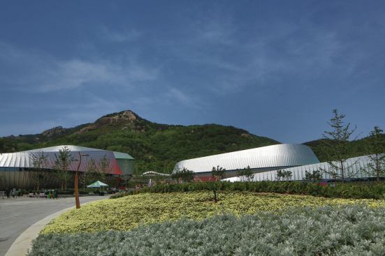 The building skins are assemblies of standardized metal components cut and bent into cylindrical, conical, and flat panels.