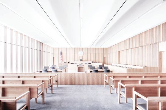 The wood-paneled courtrooms are positioned in the corners of the building.