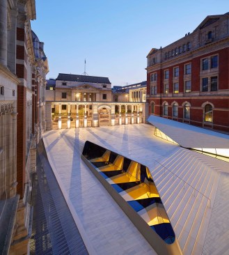 The new courtyard of the Victoria & Albert museum features 11,000 porcelain tiles, linear skylights into the underground gallery space, and a large sculpture.