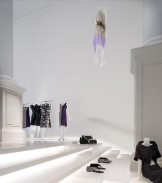 The two salons are subtly “knit” together with four-inch-deep perimeter floor troughs that house fluorescent and LED lights beneath the translucent resin. These can change color to compliment the designer’s collection.