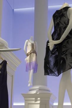 A concealed color-changing LED grazer illuminates the wall in the main salon.