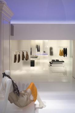 The rear salon floor trough subtly echoes the blue in the wall. The back and sidewalls are illuminated with concealed fluorescent coves and track-mounted MR16s fixtures.