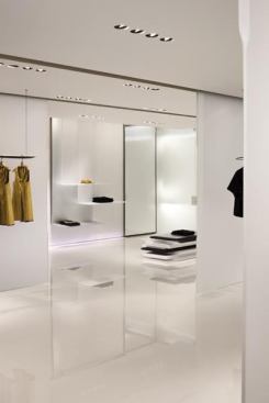 Cascading, translucent shelving units drape from the ceiling in groups of three and slide along five recessed ceiling tracks that also house air diffusers, creating a multitude of layers. MR16 light fixture housings and tracks had to be coordinated within ¼-inch due to existing structure and HVAC systems.