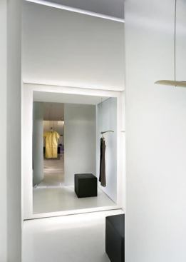 In the fitting rooms the combination of LED grazing lights in the flow and the ceiling of the three-inch glass wall cavities and dimmable indirect fluorescent behind the mirror combine to create a soft, flattering light.