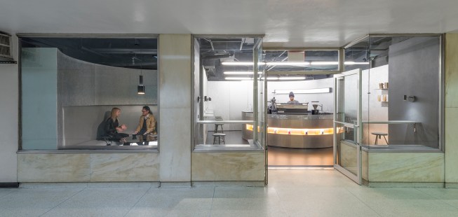 The design for Voyager Espresso in New York City’s Financial District is inspired by the café’s spacecraft namesake, with a futuristic material palette of perforated aluminum, copper, and black marble. The space is centered around multiple circular elements including a counter for baristas and banquette seating for visitors.