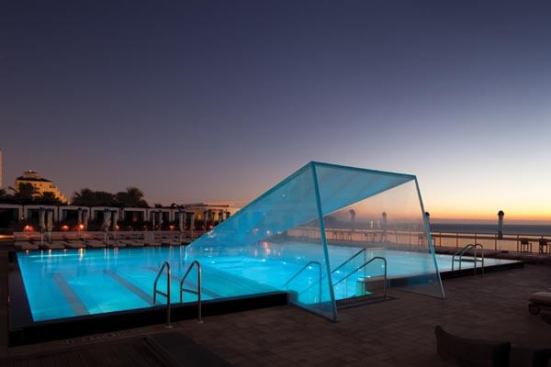 The pool stair is encased in resin and allows guests to walk back down into the lobby. Given the lighting restrictions—the adjacent beach is a sea turtle breeding ground—the pool and stair enclosure are the primary nighttime illuminated features. The lighting is intended to evoke the ethereal sense of walking through water.