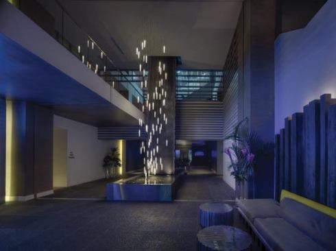 Low ambient light levels and the sound of falling water greets guests as they enter the hotel. The “flying” candle fixtures are designed as a sculptural art element.